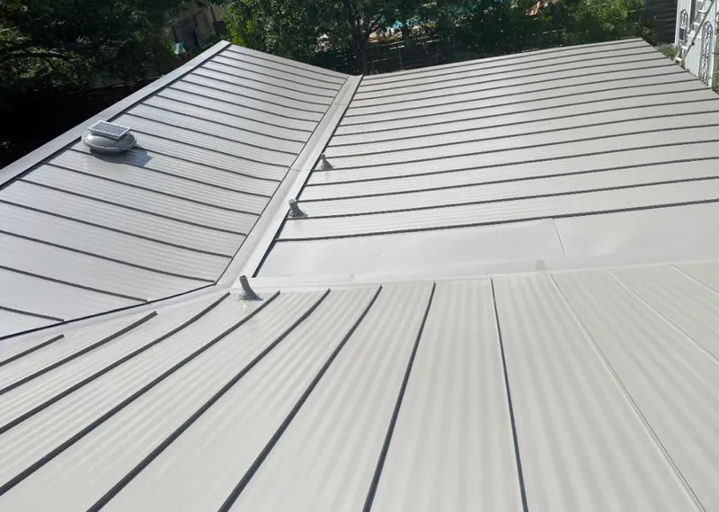 Solar attic fan installed on a metal roof for Roof Ventilation in Old Westbury